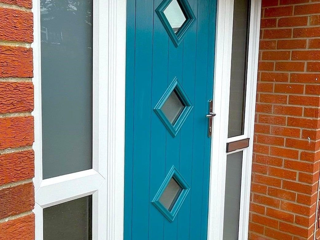 A teal composite front door with glass side panels