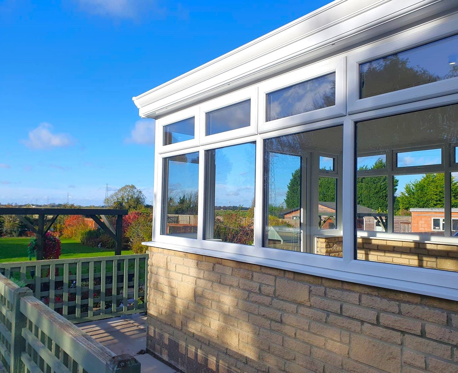 White glazing around a garden room on a brick base