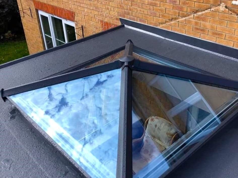 A grey roof lantern on a flat roof